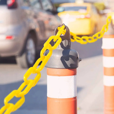 200 Ft Yellow Plastic Chain Barrier for Crowd Control and Event Decor installed on traffic cone outdoors