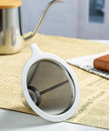 Side view of an Upgraded Stainless Steel Pour Over Coffee Filter Dripper For One To Two Cups With 800 Mesh Slow Filter on a table.