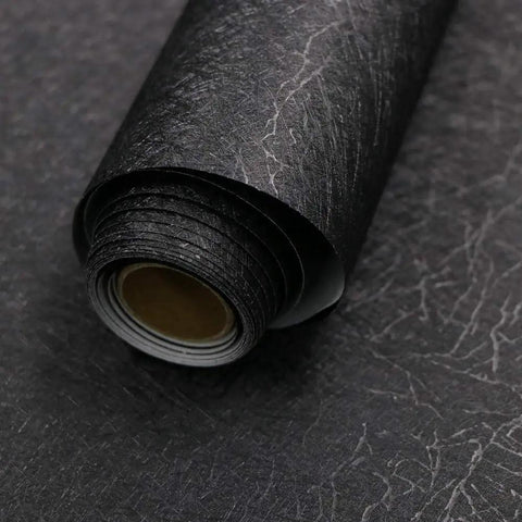 Close-up of Slick Self Adhesive Black Silk Wallpaper Peel And Stick With Embossed Texture showing roll with matte finish