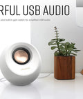 Pebble V3 2.0 USB C Desktop Speakers With USB Audio And Bluetooth 5.0 beside potted plant on desk, white