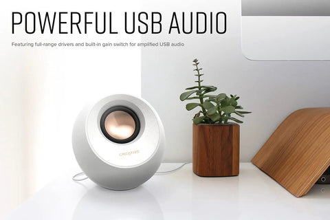 Pebble V3 2.0 USB C Desktop Speakers With USB Audio And Bluetooth 5.0 beside potted plant on desk, white
