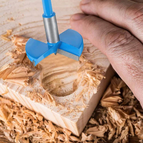 Blue 48mm woodworking hole saw drill bit with hex handle drilling into wood.
