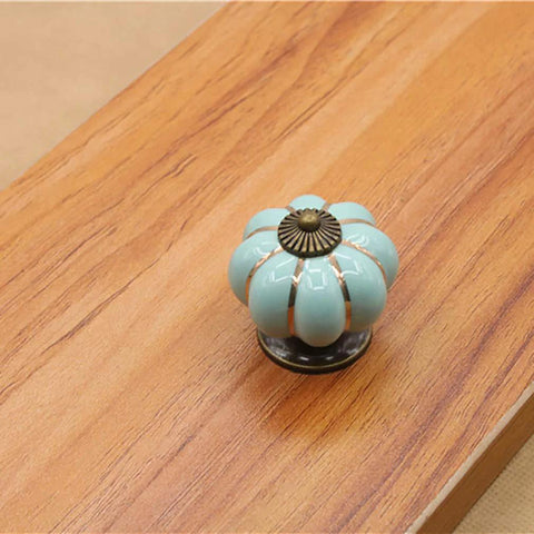 Sky blue ceramic pumpkin cabinet knob on wood surface from 5 Pack Retro Vintage Ceramic Pumpkin Cabinet Knobs Set For Kitchen Cabinets Drawers Dresser Cupboard Pull Handles Includes 3 Kinds Of Screws Sky Blue Enhances Vintage Charm For Furniture With Easy Install And Durable Gloss Finish