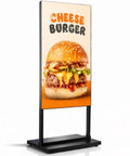 Crisp 55 Inch 4K Floor Standing Digital Signage Screen displaying a vibrant cheese burger advertisement on a black base.