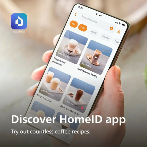 Person holding a smartphone displaying HomeID app with coffee recipes including iced coffee and latte macchiato.