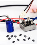 Heavy Duty US1K 1A 800V Rectifier Diodes 100 Pack on workbench with capacitor and wires for automotive repairs.