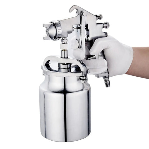 Professional Grade Hvlp Paint Sprayer Pneumatic Suction Feed Gun with Adjustable Air Valve in hand, featuring shiny stainless steel finish.