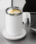 Slick 2 In 1 Self Stirring Heated Coffee Mug With Automatic Mixing And 3 Chill Proof Temp Modes For Coffee Milk Cocoa Protein Shakes 300 Ml Stainless Steel on a white heating base.