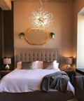 Eight Light Gold Crystal Firework Dandelion Chandelier With Modern Semi Flush Mount Ceiling Light Fixture in a bedroom setting