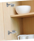 Rock Solid Stainless Steel Concealed Cabinet Hinges With Slick Silent Soft Close Self Closing Design For Kitchen Cupboards mounted on wooden shelf.