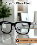 Black plastic rectangular eyeglasses viewed from the front on a reflective surface