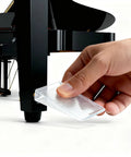 Heavy Duty Clear Plastic Shims And Leveling Wedges For Wobbly Toilets Furniture And Appliances Trim To Fit Stackable Non Slip Stabilizers being inserted under a piano leg.