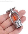 Heavy Duty 57 Degrees Pendent Fire Sprinkler Head Featuring Sleek Side Hidden Mounting For No Sweat Quick Setup And Rock Solid Fire Extinguishing System Protection In Any Building in hand, showcasing chrome finish and heat sensor.