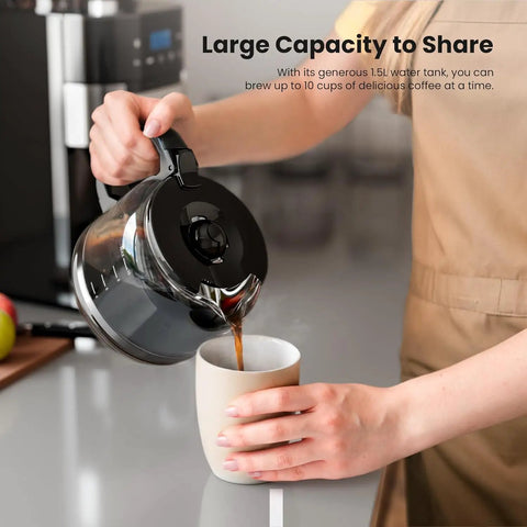 Fresh Ground Bean To Cup Drip Coffee Maker With Built In Auto Grinder pouring coffee into a cup from a glass carafe.