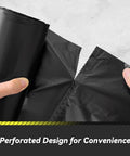 Hands tearing a perforated black trash bag from a roll, highlighting the 100 Count 55 To 60 Gallon Black Trash Bags Heavy Duty Tear Resistant And Extra Sturdy Commercial Can Liners For Big Jobs Like Lawn And Leaf Cleanup Outdoor Waste Hauling