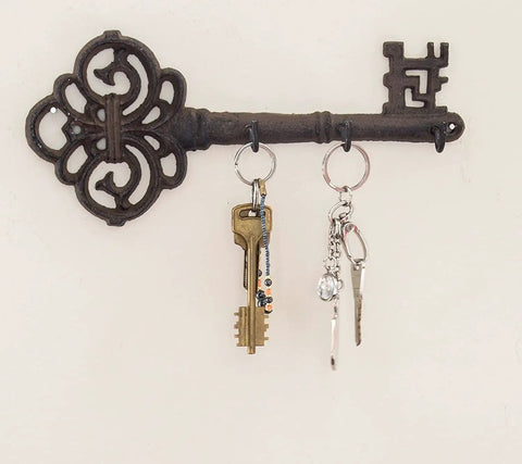 Brown Cast Iron Skeleton Key Wall Hook With Three Heavy Duty Coat Holders For Classic Farmhouse Vibes And Simple Down Home Entryway Organization Built Rock Solid For Everyday Hanging with keys and bags.