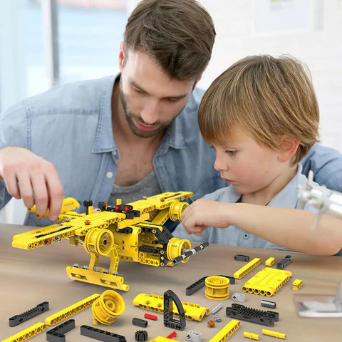 Adult and child assembling yellow prop plane from 2-In-1 Dump Truck And Propeller Plane Build Kit For Kids Aged 5 To 12, 361+ Pcs DIY STEM Construction Toy