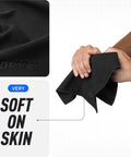 Close-up of black Pocket Sized Sweat Towels For Face Hands And Body On The Go Quick Dry Microfiber Handkerchiefs being held, showing softness.