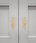 Sleek Dope Solid Wood Cabinet Pull Handle Set For Cabinets, 96mm Aluminum Wood Bar Pull With Gold Finish, mounted on gray doors