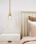 Teardrop Crystal Pendant Light With Gold Brushed Brass Finish One Light Mini LED Fixture in bedroom next to nightstand