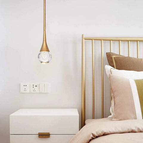 Teardrop Crystal Pendant Light With Gold Brushed Brass Finish One Light Mini LED Fixture in bedroom next to nightstand