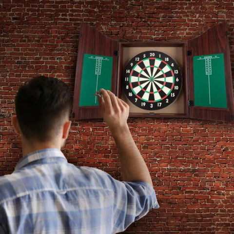 Man playing with Official Sized Dart Board Cabinet Set With 18 Inch Dart Board, 6 Steel Tip Darts, And Chalkboard Scoring