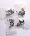 Front view of waterjet on/off valve repair kit parts in four bags; brass bushings, blue spacers, metal discs, O-rings.
