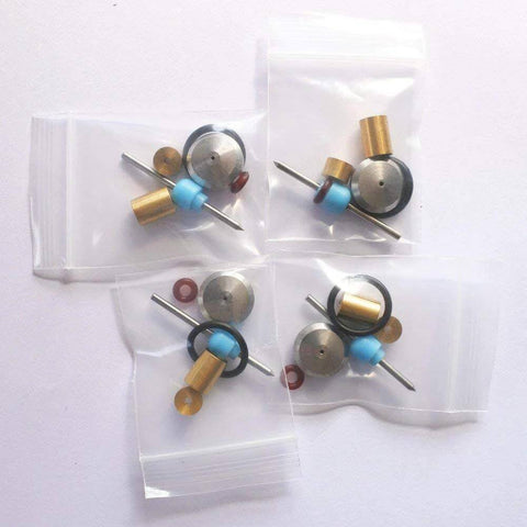 Front view of waterjet on/off valve repair kit parts in four bags; brass bushings, blue spacers, metal discs, O-rings.