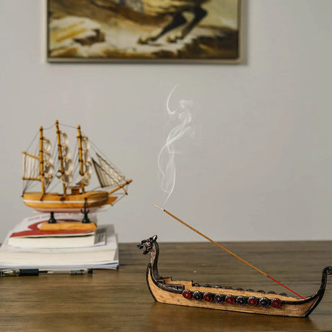 Hand Carved Dragon Boat Incense Holder For Stick Incense Burners on wooden table with smoke rising, distinctive dragon censer ornament.