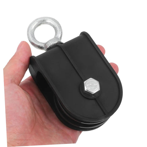 Heavy Duty Pulley Block Built Tough With Silent Rotating Wheel For DIY Home Gym Cable Systems Swivel Lifting Pulleys That Run Smooth Detachable Roller Wheel For Easy Setup And Smooth Operation black pulley block with metal eye and bolt, held in hand