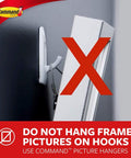 Close-up of wall with white hook and a red X; text warns against using hooks for framed pictures, suggesting alternative hangers.