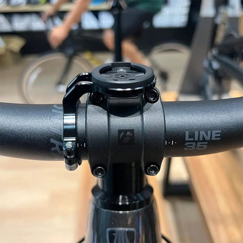 Close-up of 35mm Handlebar Bike Stem Mount For Garmin Edge Wahoo ELEMNT Bryton, black aluminum, front view on bike handlebars.