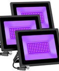 Three 100W UV Black Light Flood Lights With 6Ft Plug Cable emitting bright purple glow, ideal for blacklight parties and stage lighting.