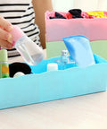 Stackable Plastic Drawer Organizers In Snazzy Pink For Crushing Closet Clutter And Laid Back Home Storage Setup holding bottles.