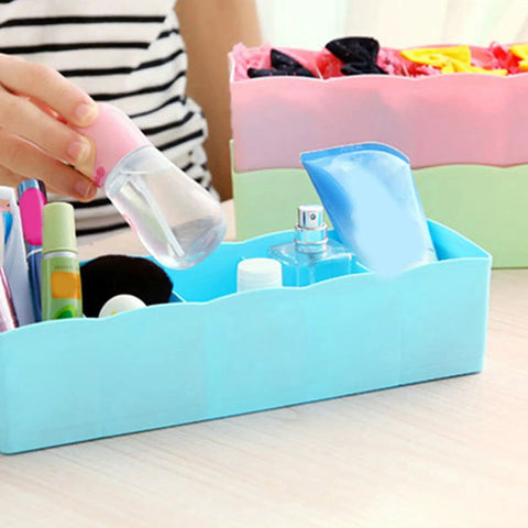 Stackable Plastic Drawer Organizers In Snazzy Pink For Crushing Closet Clutter And Laid Back Home Storage Setup holding bottles.