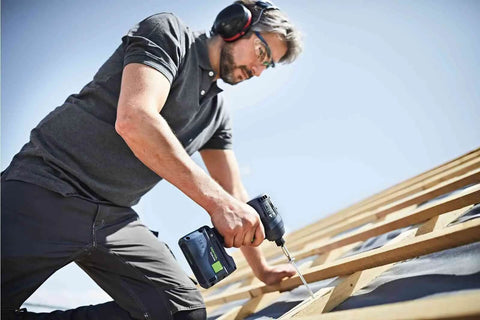 Man using Kickass Cordless Impact Drill And Driver With Brushless EC-TEC Motor 18V System to fasten wood beams.