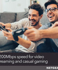 Two people gaming on a couch with WiFi Range Extender With AC1200 Dual Band, Extends Coverage Up To 1500 Sq Ft, FastLane Technology