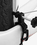Close-up of a Spoke Tool With Spanner And Strap Compact Wheel Truing Stand on a bike tire for rim alignment and repair.