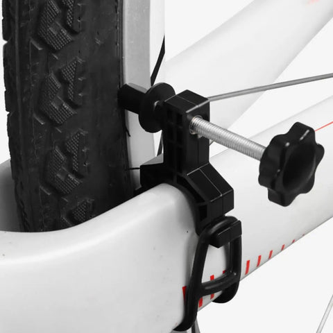 Close-up of a Spoke Tool With Spanner And Strap Compact Wheel Truing Stand on a bike tire for rim alignment and repair.