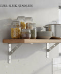 Beefy Heavy Duty Stainless Steel Wall Shelf Bracket L Shape Support installed in kitchen with jars and cookware on wooden shelf