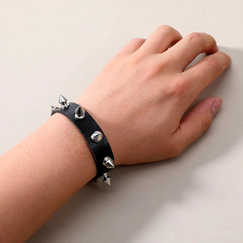 Dope Three Piece Leather Punk Set Featuring Spiked Gothic Choker And Dual Studded Wristbands For Savage Street Style Rock Edge Heavy Metal Fits Perfectly showing a close-up of a spiked wristband on a hand.
