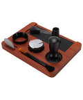 Solid Wood Espresso Tamper Station With Silicone Mat And Seven Piece Barista Gear featuring black accessories and wood base for home brewing.