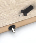 Close-up of No Fuss Slam Free Cabinet Door Repair Pins And Soft Close Damper Pack 20 Piece Heavy Duty Plastic Stopper installed in wood.
