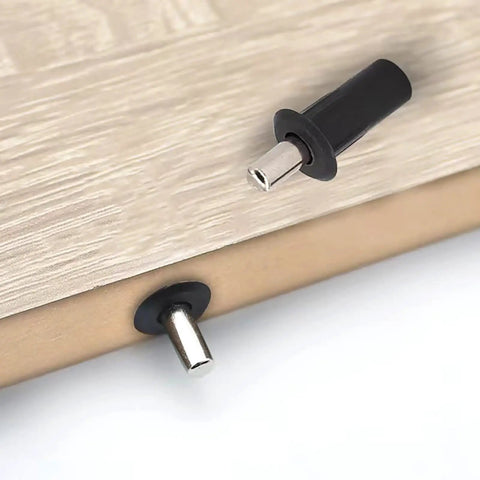 Close-up of No Fuss Slam Free Cabinet Door Repair Pins And Soft Close Damper Pack 20 Piece Heavy Duty Plastic Stopper installed in wood.