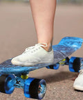 Child riding Complete Mini Cruiser Skateboard For Kids And Beginners 22 Inch Starry Sky Retro Deck with smooth 60mm wheels
