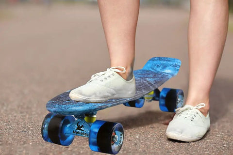 Child riding Complete Mini Cruiser Skateboard For Kids And Beginners 22 Inch Starry Sky Retro Deck with smooth 60mm wheels