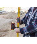 Universal Green and Red Rotary Laser Detector With Dual Sided LED Backlit Display IP54 Dust and Water Protection Fine and Coarse Modes For Precise Leveling And Quick Audible Visual Readouts Pro Grade Easy Read mounted on leveling rod at construction site