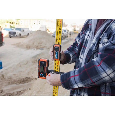 Universal Green and Red Rotary Laser Detector With Dual Sided LED Backlit Display IP54 Dust and Water Protection Fine and Coarse Modes For Precise Leveling And Quick Audible Visual Readouts Pro Grade Easy Read mounted on leveling rod at construction site