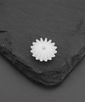 Single bevel gear from Bevel Gear Set 16T Module 0.5 With 1.95mm Bore 5.3mm Thick 20Pcs Transmission Gears on slate surface.