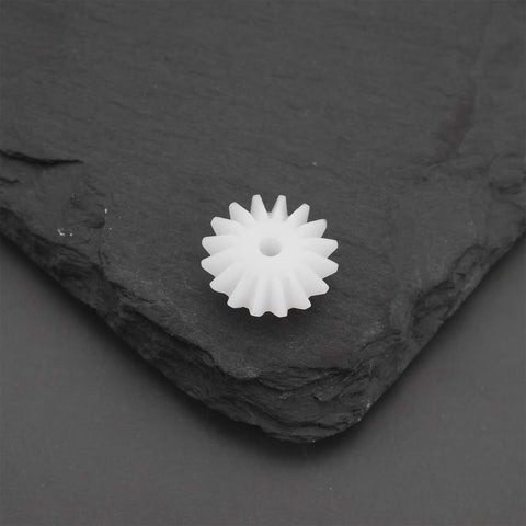 Single bevel gear from Bevel Gear Set 16T Module 0.5 With 1.95mm Bore 5.3mm Thick 20Pcs Transmission Gears on slate surface.